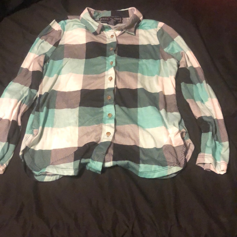 A button down blue, teal, black, and white shirt.